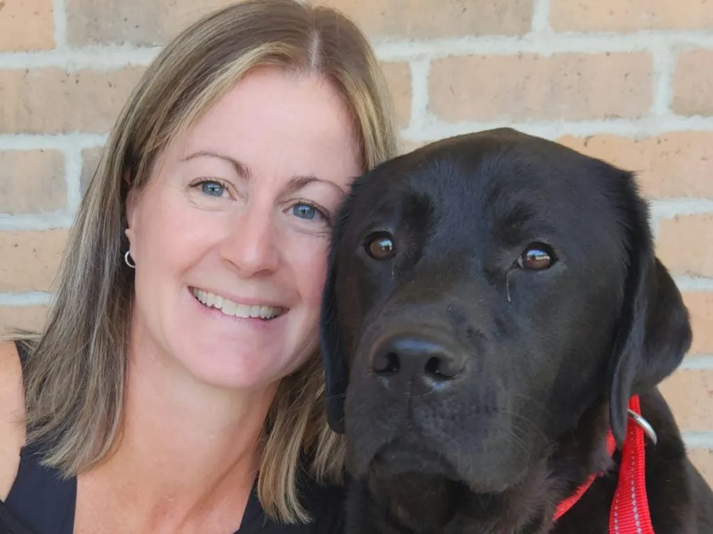 Une dame souriante avec un labernois noir